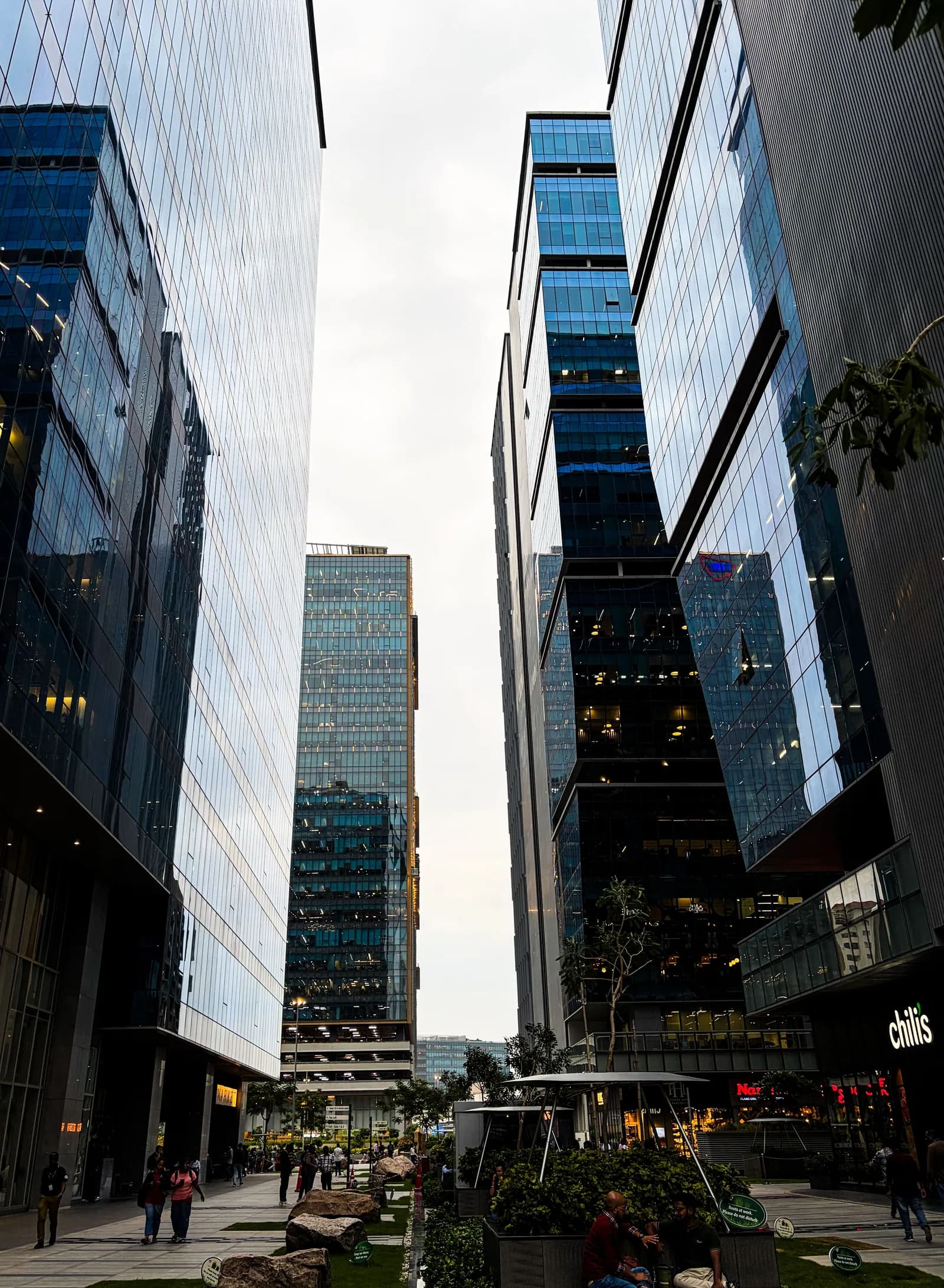 A dramatic upward view of glass office towers in Nairobi's central business district.